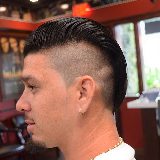 Adrian Mitchell's slicked back style with undercut